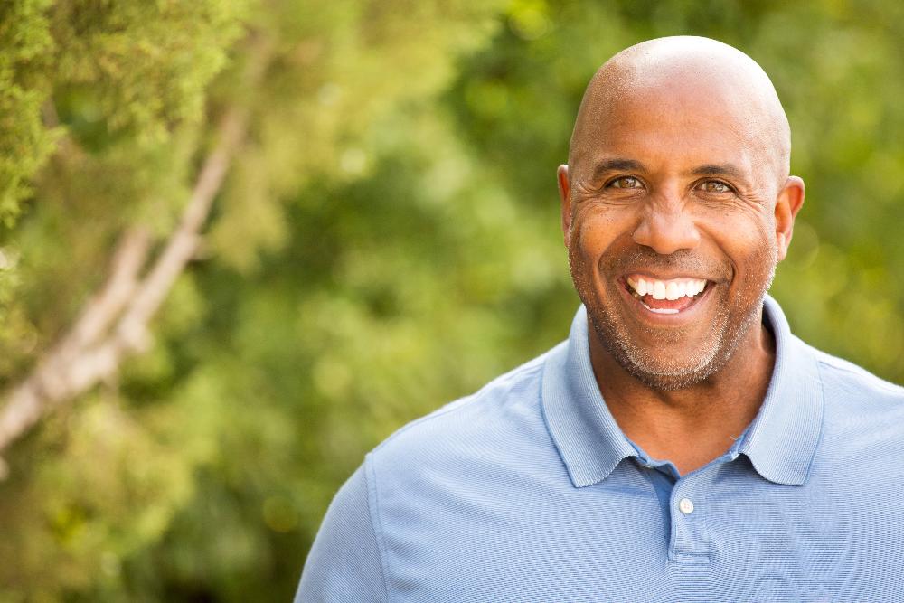 man smiling after replacing missing teeth in lithia, FL